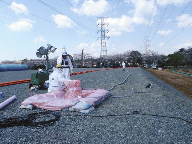 汚染水漏れが発生した地下貯水池で、対応に追われる作業員＝２０１３年、東京電力提供
