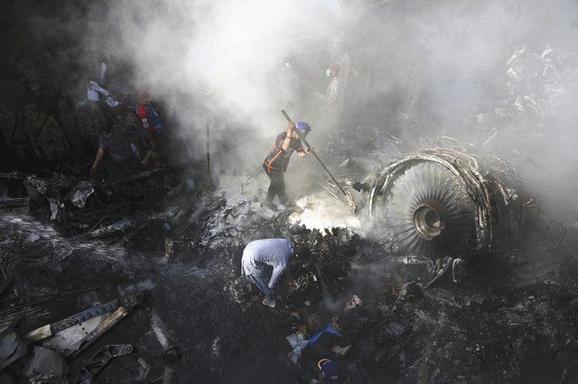５月２２日、パキスタン南部カラチで、墜落した旅客機の周辺で生存者を捜すボランティアら＝ＡＰ　 
