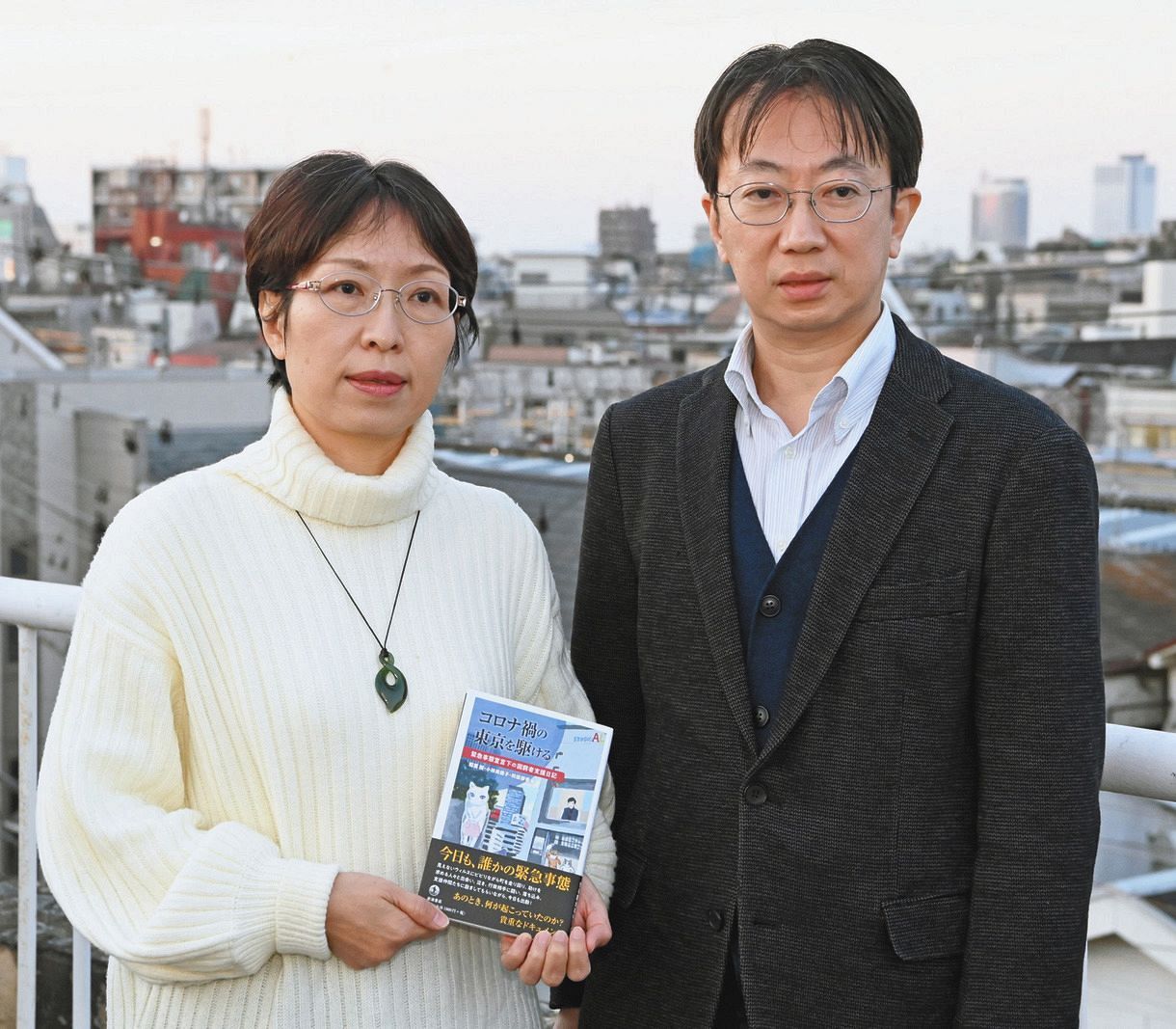 「コロナ禍の東京を駆ける」を手にする小林美穂子さん（左）と編集を担当した夫の稲葉剛さん＝東京都中野区で