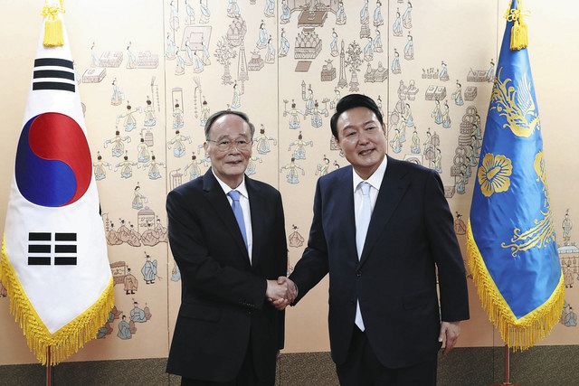 中国の王岐山国家副主席と握手する韓国の尹新大統領（ＡＰ）