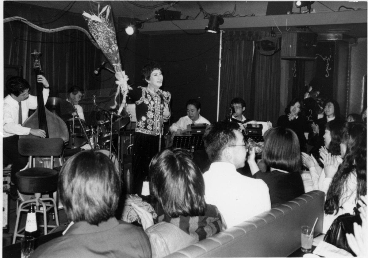 銀巴里最後のステージで花束を手にアンコールに応える美輪明宏さん＝1990年12月31日撮影、中央区で 