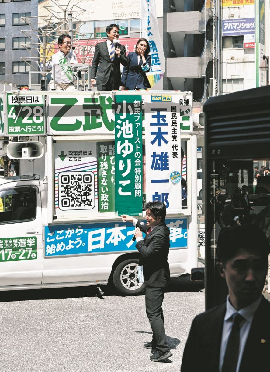 Tsubasa party representative Atsuhiko Kurokawa (front) stands in front of other candidates' camps and speaks out on April 16, 2024, in Koto Ward, Tokyo.