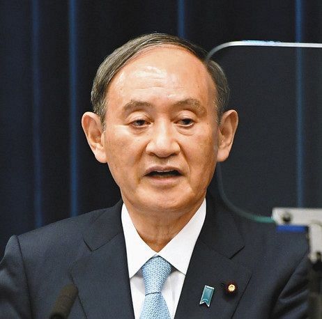 記者会見する菅首相