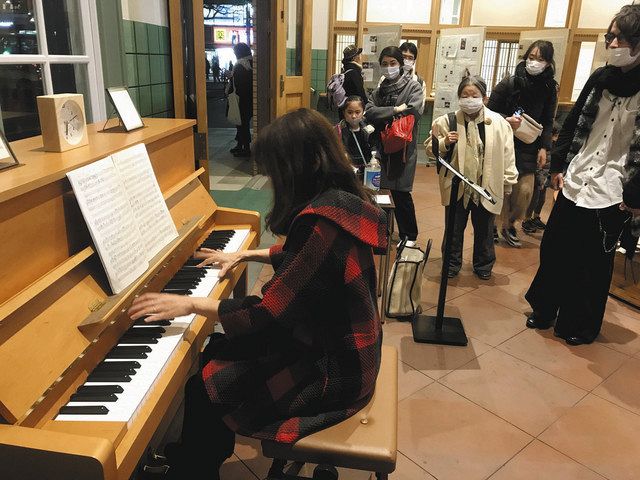 ピアノの演奏に聞き入る来場者ら＝国立市の旧国立駅舎で