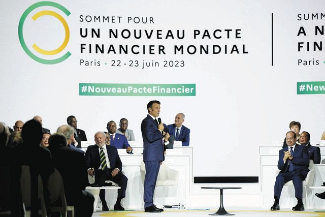 フランス・パリで開かれた途上国支援や気候変動対策への国際資金の拡充を話し合う首脳会合でスピーチするマクロン大統領（中央）＝AP