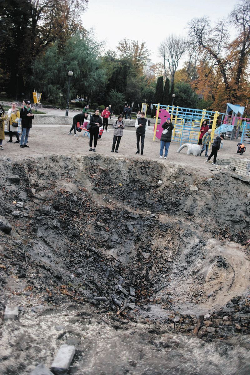 A park in Kiv with a large hole left by a Russian missile attack, October 2022, photographed by Takashi Hirano