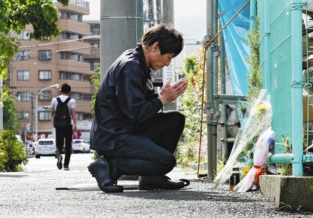 殺傷事件発生から１カ月を迎え、現場付近で手を合わせる男性＝２８日、川崎市多摩区で
