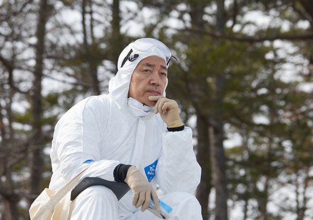 Ryuichi Sakamoto stares at the waves on the coast of the Tokyo Electric Power Company Fukushima Daiichi Nuclear Power Plant disaster area on March 11, 2014 in Futaba, Fukushima Prefecture.
