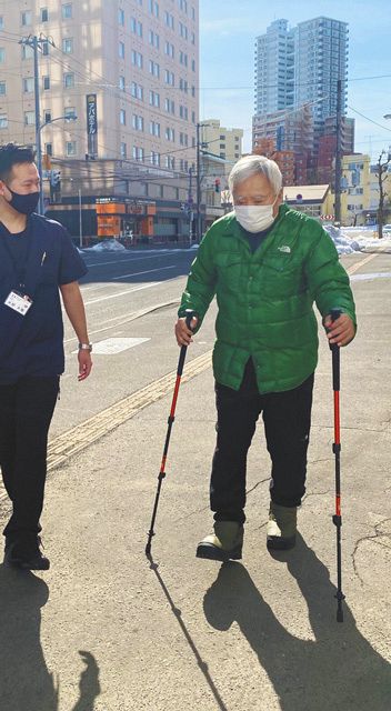 ２１年３月、札幌市の自宅前の道を歩きトレーニングする三浦さん＝ミウラ・ドルフィンズ提供