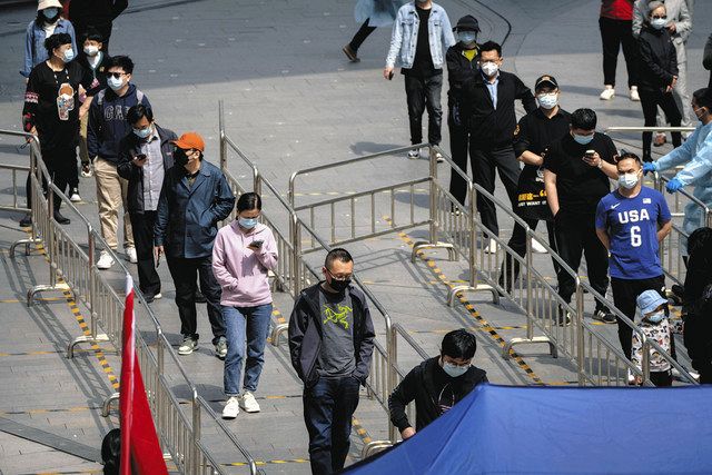 北京のオフィスビル内コロナ検査場に並ぶ人々＝4月29日（AP）