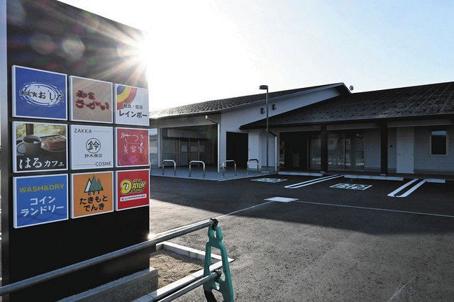 1年遅れで建設された商業施設。駐車場には入居する店舗の新しい看板が立ち、今春の開業に備えていた＝福島県大熊町で