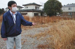 雑草が茂る自宅跡地で話す大和田信成さん＝1月26日、福島県富岡町で